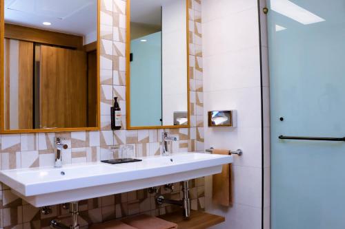 a bathroom with a sink and a shower at Hotel Riu Touareg - All Inclusive in Curral Velho