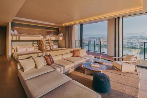 a living room with a couch and a bunk bed at FAV LUX Miyazaki in Miyazaki