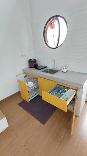 a kitchen with a sink and a mirror at Villa Takasima Berastagi in Berastagi