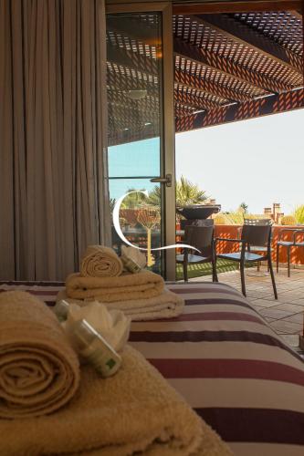 a hotel room with a bed with towels on it at Casa Lucia in Palm-Mar