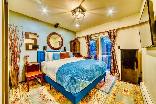 a bedroom with a large bed and a mirror at Neocolonial Nouveau Kensington Vacation Home in Vancouver