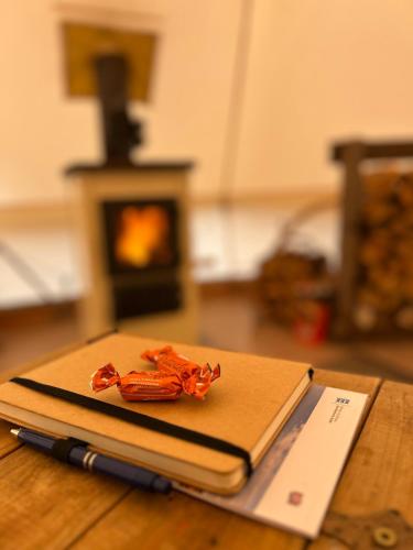 a notebook with a pen on top of it on a table at Lux Glamping, Lammas in Halliste