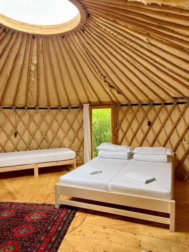 a room with a bed and a window in a yurt at Pilgerhaus Wildsteig in Wildsteig