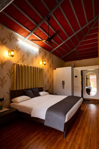 a bedroom with a large bed in a room at Shwetik Resort in Khamshet