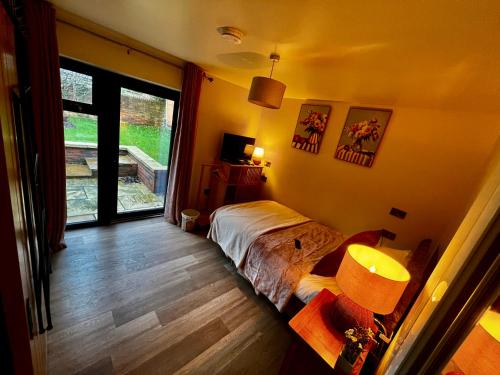 a bedroom with a bed and a large window at Havendale in Chesterfield