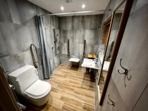 a bathroom with a toilet and two sinks at Havendale in Chesterfield