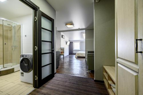 a bathroom with a walk in shower and a walk in closet at Grecheskaya Central Suites in Odesa