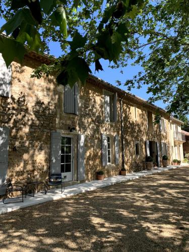 an exterior view of a building with a yard at A charming Provençal farmhouse in Mouriès