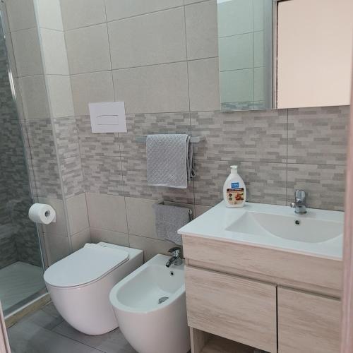 a bathroom with a sink and a toilet and a sink at FREE HOUSE in Palmi