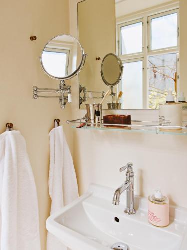 a bathroom with a sink and a mirror at Coco Hotel in Copenhagen