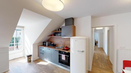 a kitchen with a white refrigerator in a room at Mestna Vila Krško in Krško