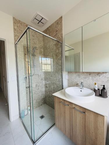 a bathroom with a sink and a shower at Feels Like Home in Wyndham Vale