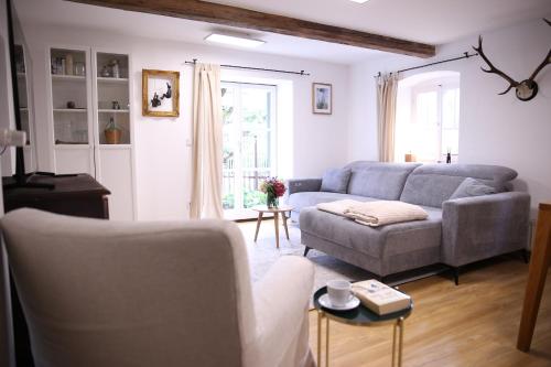 a living room with a couch and a table at Ferienwohnung Oswald mit Garten im EG in Kochel