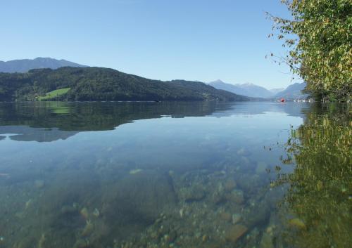 a large body of water with mountains in the background at Apartments Krista in Seeboden