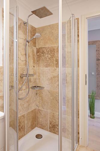 a shower with a glass door in a bathroom at Sylter Perle in List