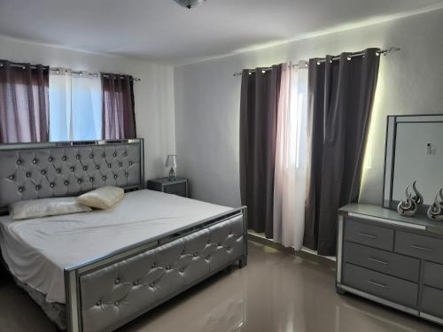 a bedroom with a bed and a dresser and a mirror at Charming home in Cancino