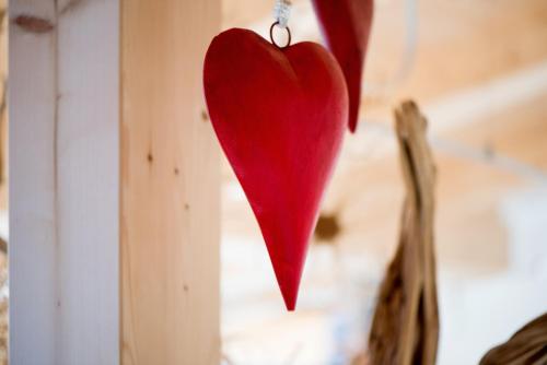 a red heart hanging on a wall at Hotel Pinei in Ortisei