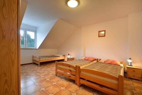 a bedroom with two beds and a window at Agroturystyka Nad Hańcza - apartament in Błaskowizna