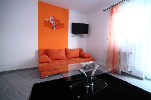 a living room with a couch and a glass table at Domki Cztery Pory Roku in Czchów