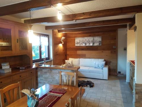 a kitchen and living room with a couch and a table at Niblet in Sauze dʼOulx