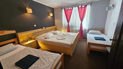 a hotel room with two beds and a window at Rooms Jagoda I Cozy Alpine Stay Near Bled in Blejska Dobrava