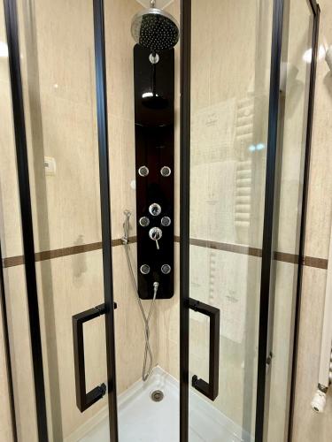 a glass shower door with a speaker in it at Hotel Pombeira in Guarda