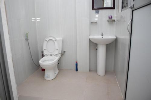 a bathroom with a toilet and a sink at Nature Park villa in Arambegama