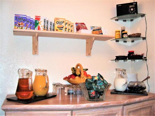 a shelf on a wall with some food and drinks at Links Side Guest House in Bude