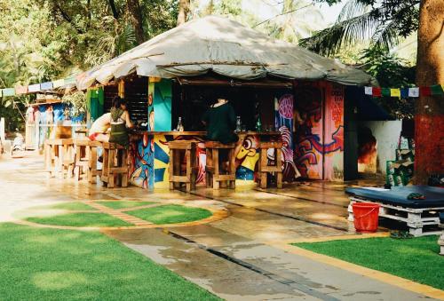 a bar with people sitting in front of it at Pappi Chulo Vagator in Vagator