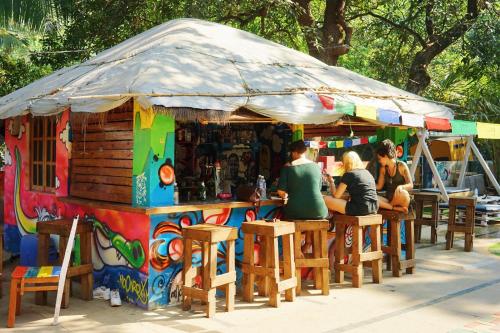 a group of people sitting at a bar at Pappi Chulo Vagator in Vagator