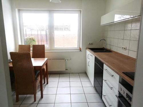 a small kitchen with a table and a window at lichtdurchflutete 2 Zimmer Wohnung in Dinslaken