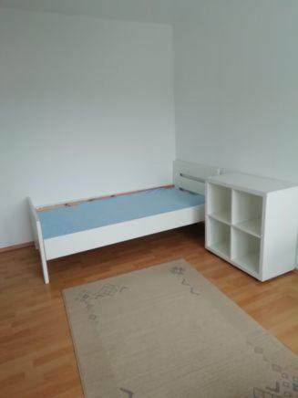 a room with a bed and a desk and a rug at lichtdurchflutete 2 Zimmer Wohnung in Dinslaken