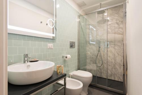 a bathroom with a sink and a toilet and a shower at Vittoriano Suite in Rome