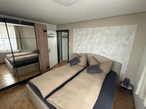 a large bed in a room with a bedroom at Ferienwohnung Edelweiss in Wolfhalden 