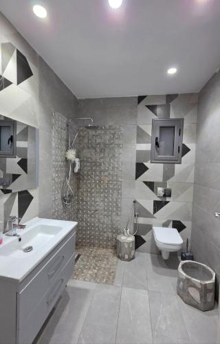 a bathroom with a sink and a toilet and a shower at Luxury Prestige Villa in Midoun