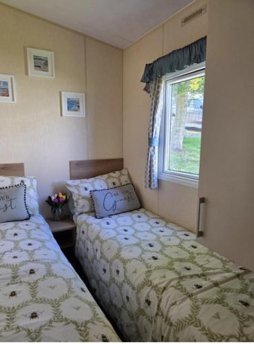 a bedroom with two beds next to a window at Seabreeze in Goodrington