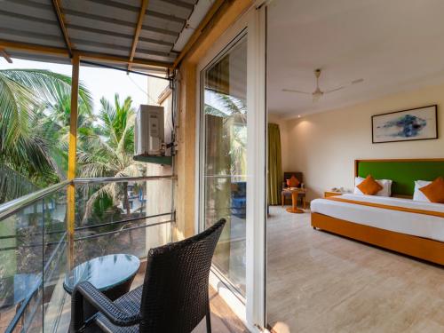 a bedroom with a bed and a large window at Trevon Hotels & Resorts Candolim Goa in Candolim