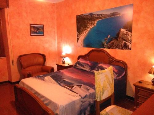a bedroom with a bed and a painting on the wall at B&B Bella Vista in Dorgali