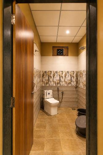 a bathroom with a toilet and a sink at Gir Wildtrack Lodge - Into the Deep Forest in Sasan Gir