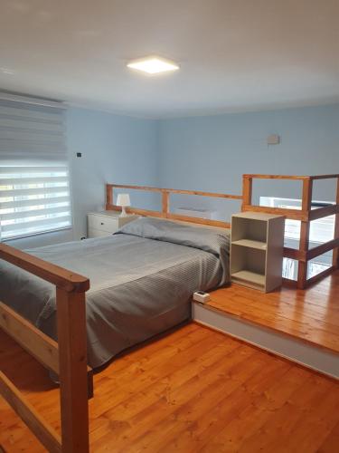 a bedroom with a bed and a wooden floor at Dimora Li Vinti in Cicciano