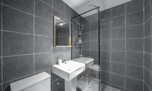 a black and white bathroom with a sink and a toilet at Pohang Villa Dahlia in Pohang