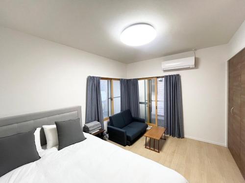 a hotel room with a bed and a chair at Hotel Suite1 Quiet Family Stay Near Tokyo in Warabi