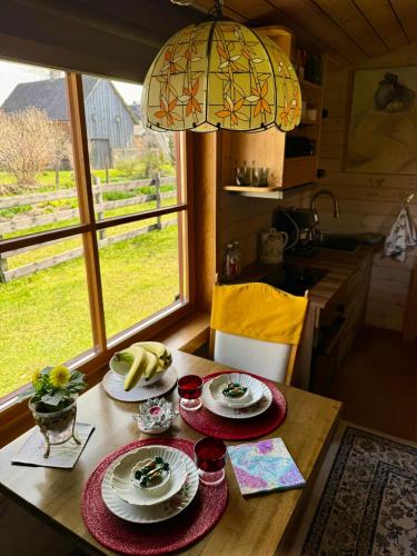 a table with plates of food on it in a kitchen at Goldingen Stone Retreat - Hot Tub and Nature in Kuldīga