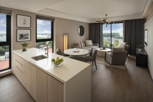 a kitchen and living room with a couch and a table at Modena by Fraser Vinh Yen in Yen