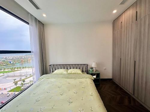 a bedroom with a bed and a large window at 1BR Olive & Rouge House in Long Bình