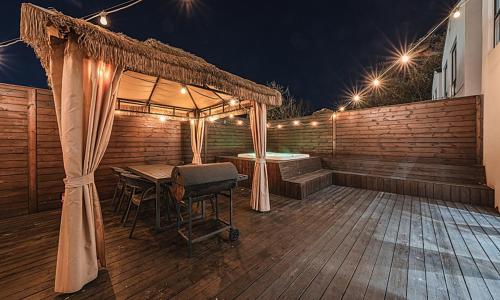 a wooden deck with a tent and a table and a tub at Chuncheon Bali 376 in Chuncheon
