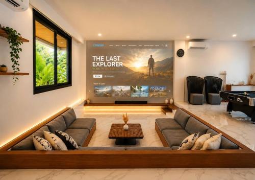 a living room with a couch and a movie poster at Gandum Villa Complex - Luxury Boutique Stay Uluwatu in Uluwatu