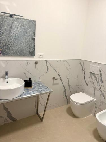 a bathroom with a sink and a toilet at Duca d Aosta apartment 2 in Monfalcone