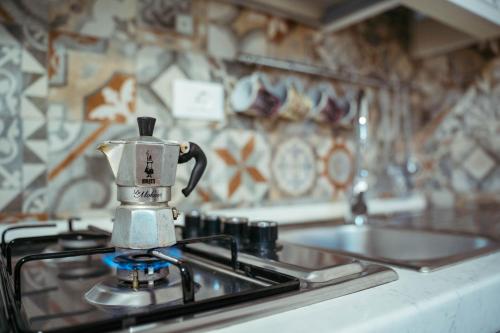 a coffee pot sitting on top of a stove in a kitchen at Gold Palace ***** in Ferrara