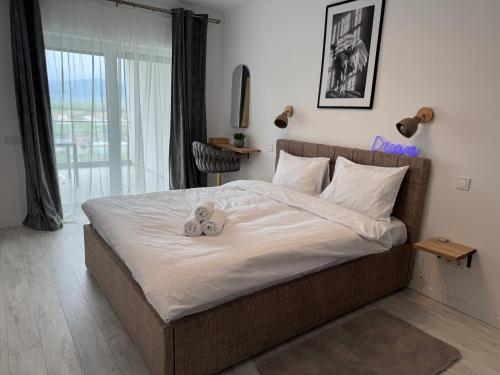 a bedroom with a bed with two teddy bears on it at DaVinci Apartments VRT in Cristian